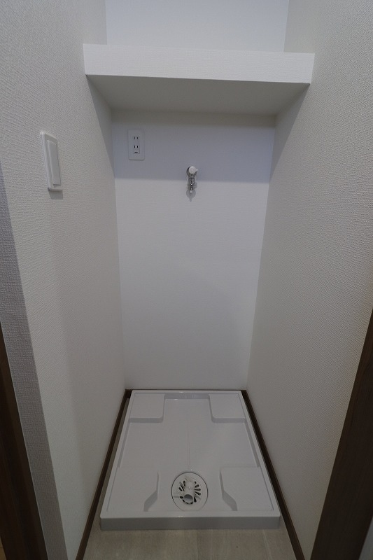洗濯機はここ。