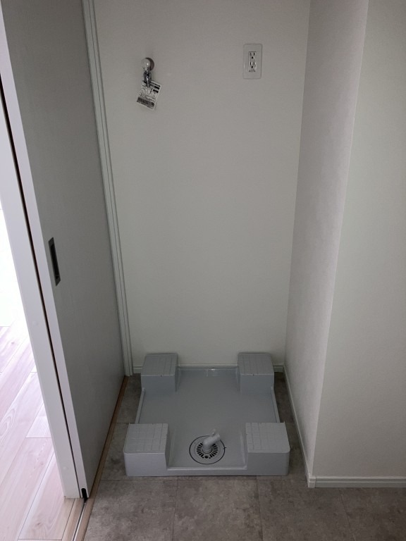 洗濯機はここ。